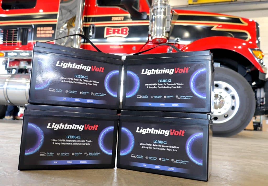 Image of LightningVolt lithium APU batteries in front of an ERB truck